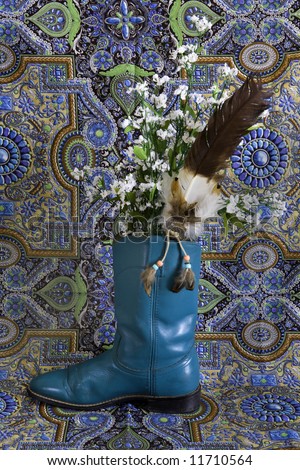 Blue roping boot with feather and flowers.