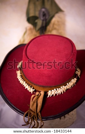 Red leather hat with snake bone necklace and bag.