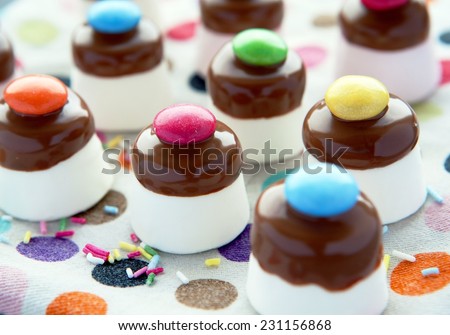 Marshmallow Top Hats with Chocolate Smarties Party Treats Group on spotty background