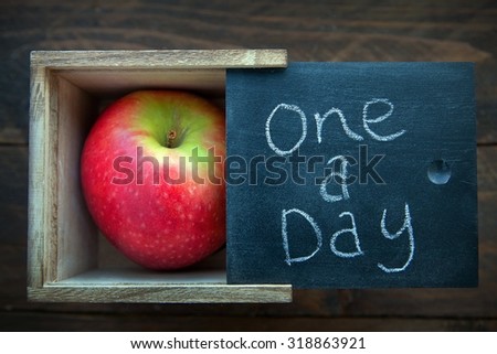 Apple in a natural wooden box. One a day keeps the Doctor away