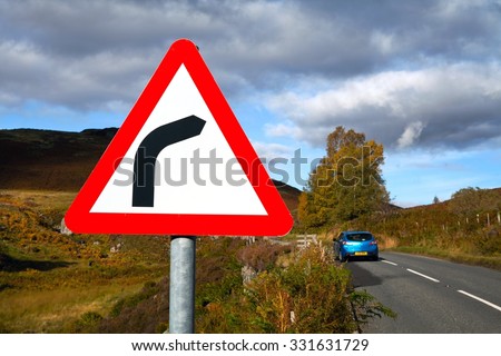 Right bend warning triangle sign on a country road