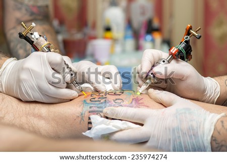 Tattoo artist at work. Closeup