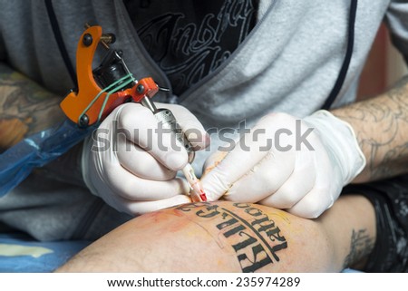 Tattoo artist at work. Closeup