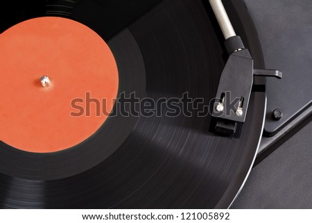 Detail of vintage record player with spinning vinyl. Motion blur image.