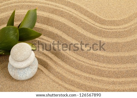 background with balance zen stones in sand and green leaves