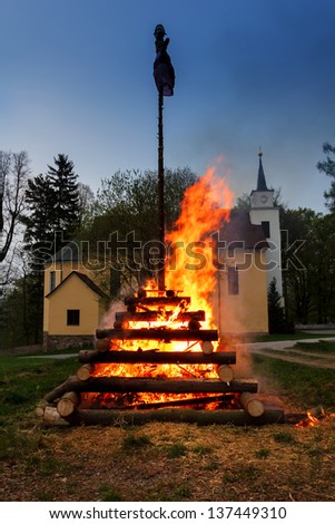 walpurgis night burning wood and religion cross with huge flames