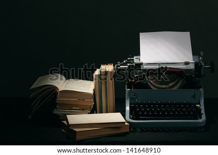 Old typewriter with paper and books, retro colors on the desk