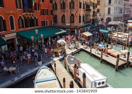 ITALY, VENICE - JULY 16: Crowd of tourist near Grand Canal on July 16, 2012 in Venice. More than 20 million tourists come to Venice annually.