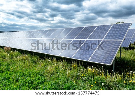 Solar energy panels against dramatic storm sky