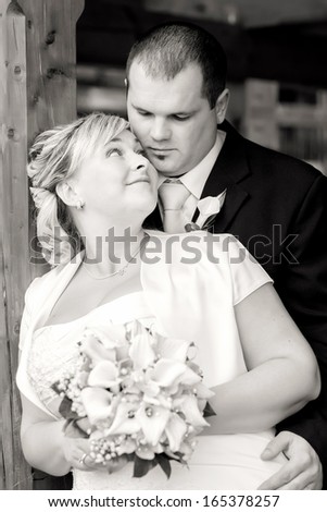 beautiful young wedding couple, bride looking to her groom, black and white tone