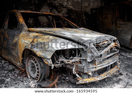 Close up photo of a burned out car in garage after fire for grunge use