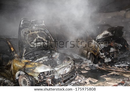 Close up photo of a burned out cars in garage after fire for grunge use