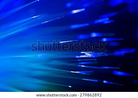 bunch of optical fibres flying from deep as blurred abstract technology background