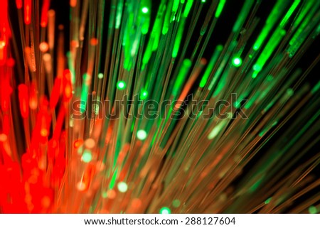 bunch of optical fibres flying from deep as blurred abstract technology background
