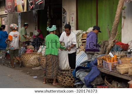 PENIDA ISLAND, INDONESIA - JUNE 30.2015: woman Hindu at the traditional daily street market, village Toyopakeh, Nusa Penida, Bali June 30. 2015 Indonesia