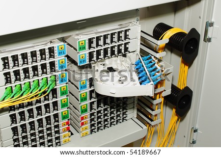fiber optic cable management system with green and blue SC connectors