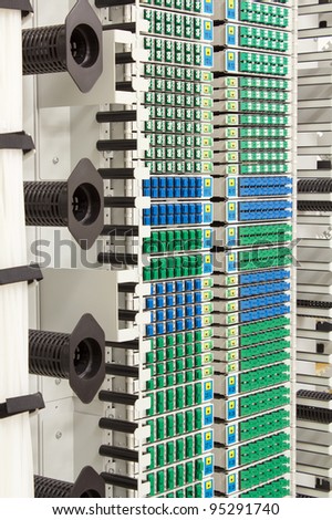 fiber optic cable management system with green and blue SC connectors