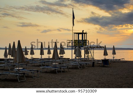 evening sunset on beach with sun beds and guardian towers