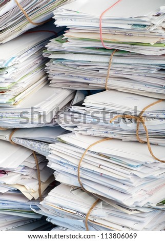 Stack of white letters and envelops on white