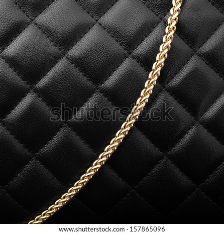 Black leather with golden chain background