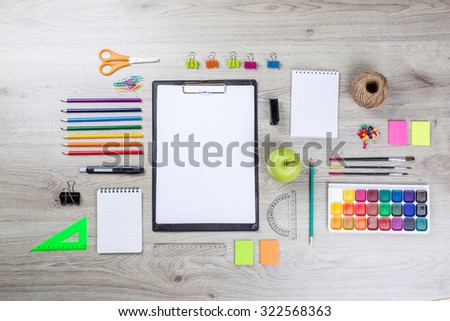 school supplies with pencils, paint pens paper scissors and rulers.