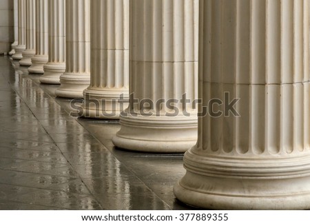 Many old greek columns with reflection