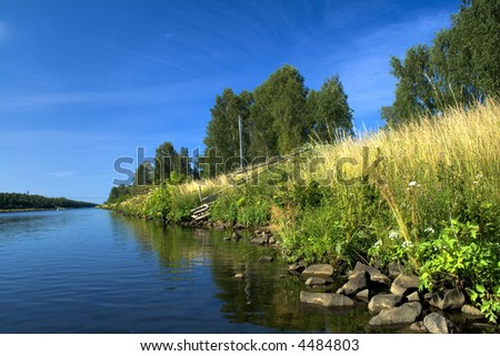 River bank against deep blue sky