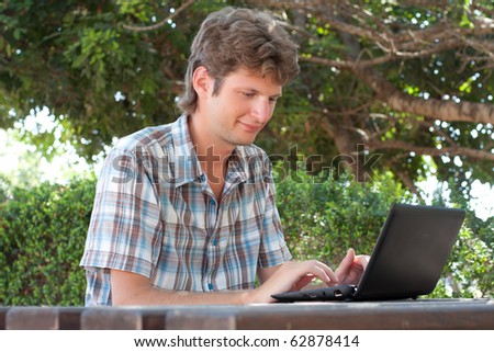 Man with laptop in the park