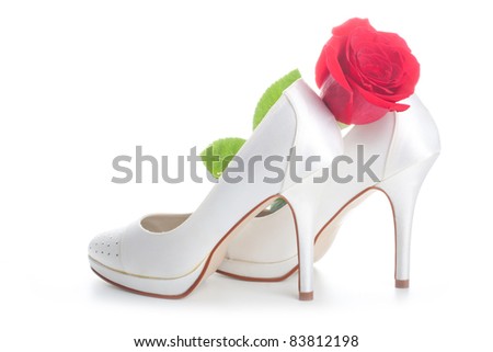 stock photo Gorgeous wedding shoes white with a red rose isolated on a