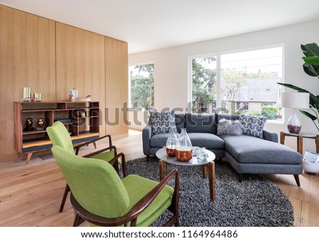 mid-century conversation room with green chairs and a blue sofa