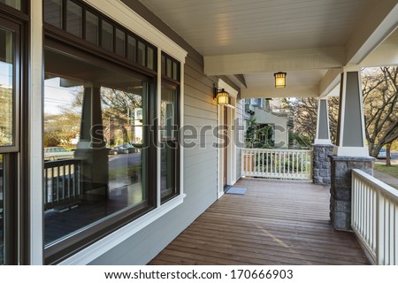 Horizontal Shot of wrap around porch on an upscale home/Large Porch Exterior of an Upscale Home