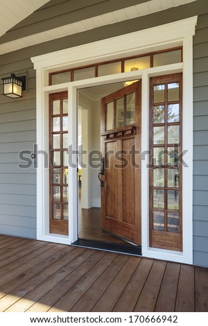 Vertical Shot Of Wooden Front Door Of An Upscale Home With Windows/Exterior Shot Of An Open Wooden Front Door