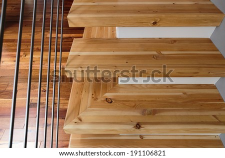 Abstract shot of modern wooden stairs/with metal wire railings, horizontal shot of a model home staircase
