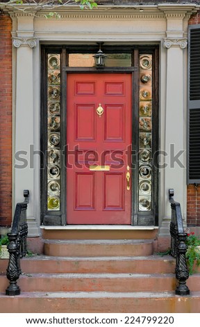 Red Front Door with Surrounding Black Door Frame and Bulls Eye Glass