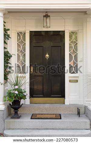 Black Front Door with White Door Frame and Side Windows over Steps with Potted Plant