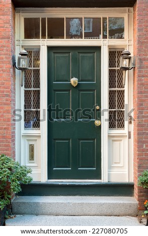 Close Up of Green Front Door with Surrounding Windows and White Door Frame