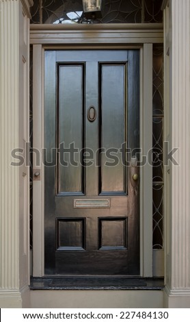 Black Front Door with Surrounding Door Frame and Windows