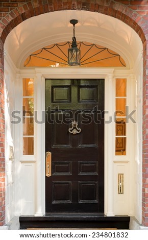 Black Front Door with Overhead Lunette and Hanging Lamp