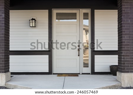 Horizontal of White And Black Front Entryway with White Siding, a White Front Door, and Black Framing