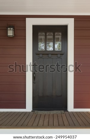 Dark Stained Wood Front Door with White Surrounding Door Frame on Red Country Style Exterior