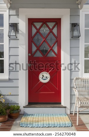 Red Front Door with Ornate Diamond Cross Hatch Window Panes and Welcome Decoration