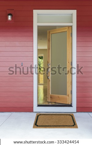 Open front door of new home with plan mat