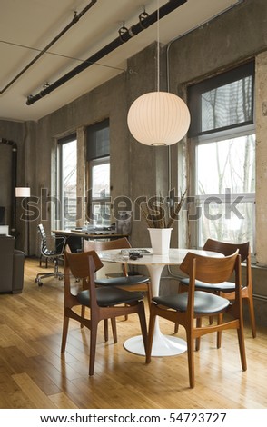 Dining room table and desk in a modern loft setting. Vertical shot.