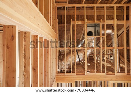Wood framing and ventilation in a home under construction.
