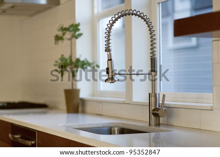 Contemporary Kitchen with Chrome Fixture and white conter tops