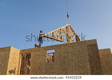 Roof Trusses Being Hoisted Onto Roof