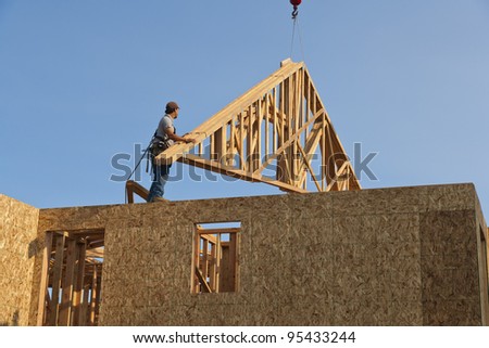 Roof Trusses Being Hoisted Onto Roof