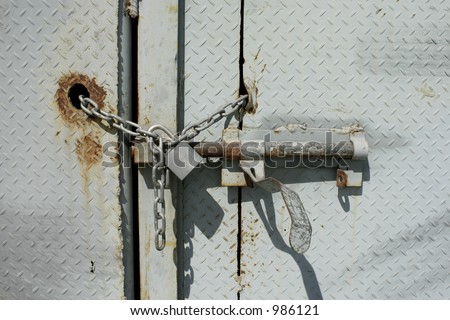 Rusty metal door with chain and lock