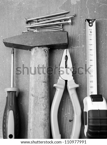 Black and white image of DIY tools and hardware used for home maintenance and repair
