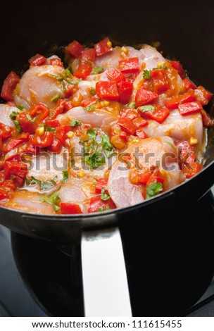 Healthy lean chicken pan fry with red peppers garnished with herbs